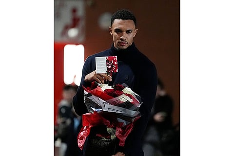 Real Madrid's Trent Alexander-Arnold lays a tribute at the Diogo Jota memorial outside Anfield, Liverpool, England.