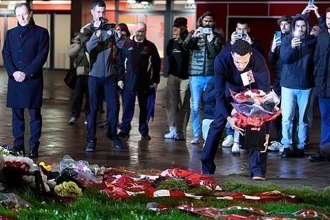 Real Madrid's Trent Alexander-Arnold lays a tribute at the Diogo Jota memorial outside Anfield, Liverpool, England.