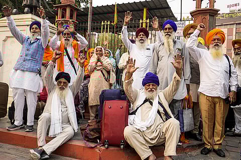 Sikh pilgrims before leaving for Pakistan to attend the birth anniversary celebrations of founder of Sikhism Guru Nanak Dev, in Amritsar.
