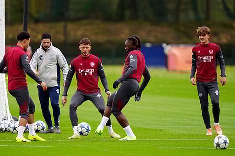 Arsenal's Eberechi Eze, center right, and Ben White, center left, during a training session in London, England.