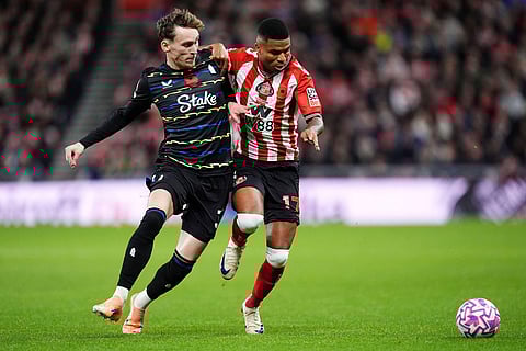 Everton's James Garner, left, and Sunderland's Reinildo Mandava in action during the English Premier League soccer match between Sunderland and Everton in Sunderland, England.