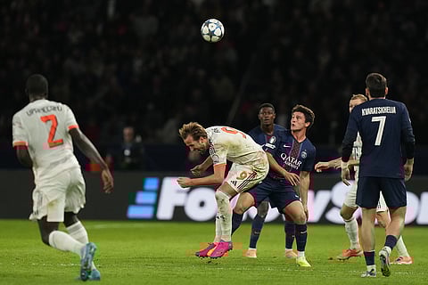PSG's Joao Neves fouls Bayern's Harry Kane during the Champions League opening phase soccer match between Paris Saint-Germain and Bayern Munich in Paris, France.