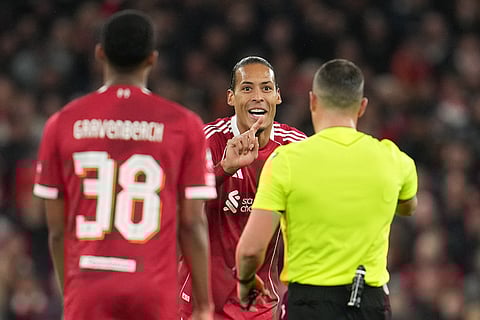 Liverpool's Virgil van Dijk argues with a referee during the Champions League soccer match between Liverpool and Real Madrid in Liverpool, England.