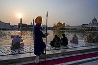 | Photo: PTI/Shiva Sharma : People sit near 'Amrit Sarovar' at the Golden Temple on the occasion of Guru Nanak Jayanti, in Amritsar.