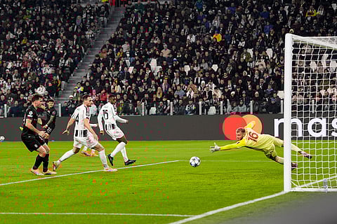Sporting's Maximiliano Araujo, second from left background, scores the opening goal during the Champions League opening phase soccer match between Juventus and Sporting CP in Turin, Italy.