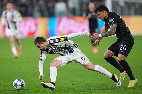 Sporting's Maximiliano Araujo, right, vies for the ball with Juventus' Edon Zhegrova during the Champions League opening phase soccer match between Juventus and Sporting CP in Turin, Italy.