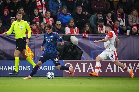 Arsenal's Max Dowman runs with the ball past Slavia's Vasil Kusej during the Champions League opening phase soccer match between Slavia Prague and Arsenal in Prague, Czech Republic.
