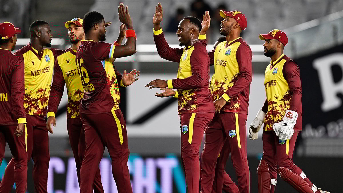 | Photo: AP/Andrew Cornaga                                           : West Indies bowler Romario Shepherd is congratulated by teammates after taking the wicket of New Zealand's Tim Robinson during the T20I match in Auckland, New Zealand, Wednesday, November 5, 2025. 