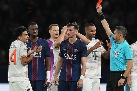 Referee Maurizio Mariani shows the red card to Bayern's Luis Diaz during the Champions League opening phase soccer match between Paris Saint-Germain and Bayern Munich in Paris, France.