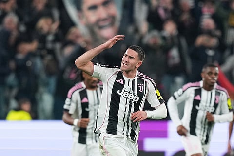Juventus' Dusan Vlahovic celebrates after scoring his side's first goal during the Champions League opening phase soccer match between Juventus and Sporting CP in Turin, Italy.