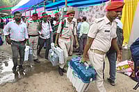 | Photo: PTI : Security personnel with EVM and other election material leave for polling duty on the eve of the first phase of the Bihar Assembly elections, in Patna.
