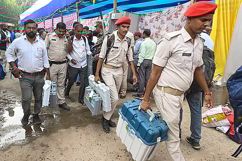 Security personnel with EVM and other election material leave for polling duty on the eve of the first phase of the Bihar Assembly elections, in Patna.