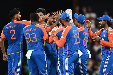 Indian bowler Axar Patel, centre, is congratulated by teammates after dismissing Australian batsman Matt Short during a T20 cricket international between India and Australia in Carrara, Australia.