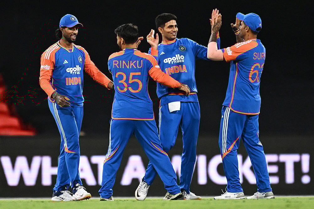 | Photo: Dave Hunt/AAPImage via AP : Indian players celebrate after winning the a T20 cricket international against Australia in Carrara, Australia.