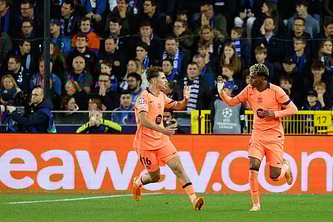 Barcelona's Lamine Yamal, celebrates his teams third goal during the Champions League opening phase soccer match between Club Brugge and Barcelona in Bruges, Belgium.
