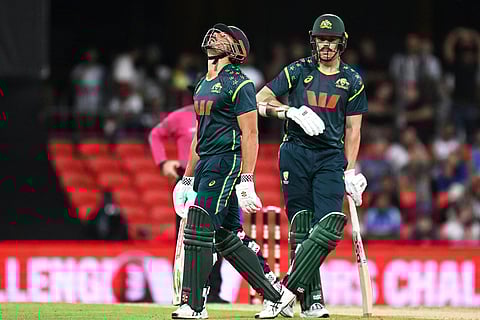 Australian batsman Marcus Stoinis, left, reacts after he was dismissed during a T20 cricket international between India and Australia in Carrara, Australia.
