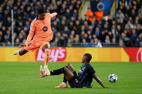 Barcelona's Marcus Rashford, left, fights for the ball with Brugge's Joel Ordonez during the Champions League opening phase soccer match between Club Brugge and Barcelona in Bruges, Belgium.