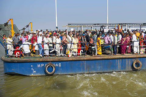 Voters onboard a ferry to cross the Ganga river before casting their votes during the first phase of the Bihar Assembly elections, at Danapur in Patna.