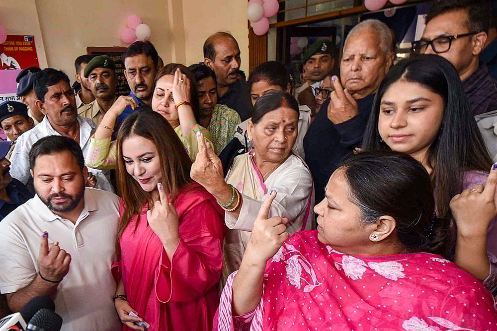 RJD leader and Leader of Opposition in Bihar Assembly Tejashwi Yadav and his wife Rajshree Yadav, party leaders and former Bihar chief ministers Lalu Prasad Yadav and Rabri Devi, party MP Misa Bharti and others show their fingers marked with indelible ink after casting votes at a polling station during the first phase of Bihar Assembly elections, in Patna. - | Photo: PTI