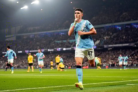 Manchester City's Phil Foden celebrates scoring the opening goal during the Champions League opening phase match against Borussia Dortmund in, Manchester, England.