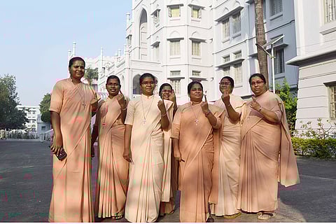 People show their fingers marked with indelible ink after casting votes at a polling station during the first phase of Bihar Assembly elections, in Patna.