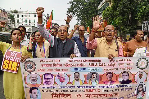 BJMTUC (Bharatiya Janata Majdoor Trade Union Council) members take part in a demonstration over Special Intensive Revision (SIR) of electoral rolls, in Kolkata.