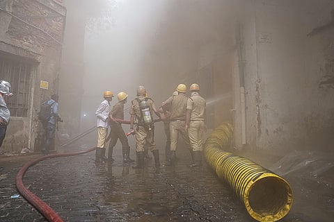 Smoke billows while firemen douse a fire at a godown at RN Mukherjee Road, in Kolkata, West Bengal.