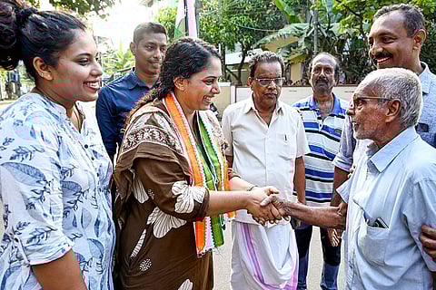 Congress candidate Sruthy interacts with a local during her campaign for the upcoming Kerala local body elections, in Thiruvananthapuram.