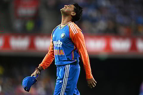 Abhishek Sharma of India reacts after dropping a catch during a T20 cricket international between India and Australia in Carrara, Australia.