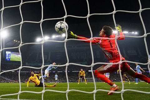 Manchester City's Erling Haaland scoring his sides second goal during the Champions League opening phase match against Borussia Dortmund in, Manchester, England.