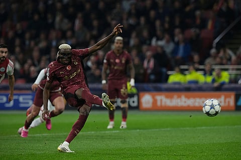 Galatasaray's Victor Osimhen scores from a penalty kick during the Champions League between Ajax and Galatasaray in Amsterdam, Netherlands.