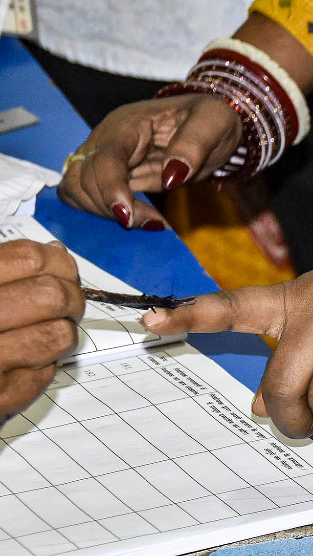| Photo: PTI : Voters show their ink-marked fingers as they deboard a ferry after casting their votes during the first phase of the Bihar Assembly elections, at Danapur in Patna.