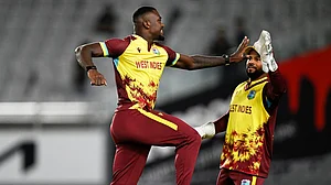 Photo: Andrew Cornaga/Photosport via AP : New Zealand Vs West Indies Live Score, 2nd T20I: Jayden Seales celebrates with teammate Shai Hope, right, after taking the wicket of Michael Bracewell in Auckland.