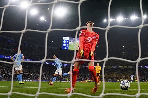 Borussia Dortmund goalkeeper Gregor Kobe reacts after Manchester City's Rayan Cherki, second from left, scoring their fourth goal during the Champions League opening phase match against Borussia Dortmund in, Manchester, England.