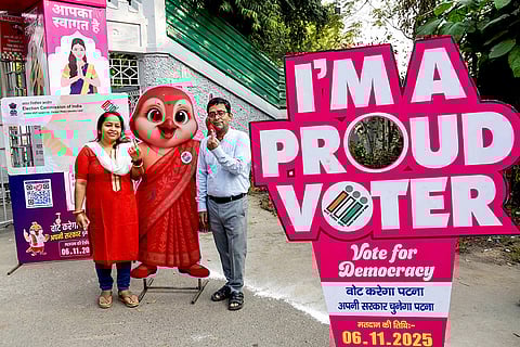 People show their ink marked fingers after casting votes at a polling station during the first phase of Bihar Assembly elections, in Patna.