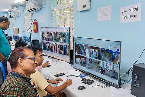 Officials monitor voting during the first phase of the Bihar Assembly election, in the control room operated under the leadership of the District Election Officer. 