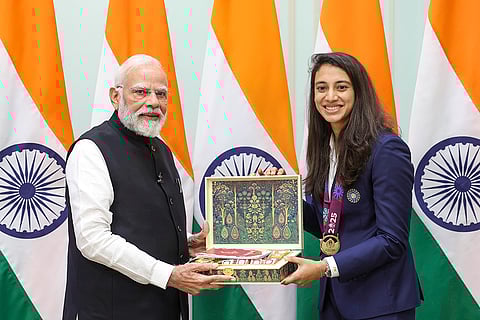 Prime Minister Narendra Modi with women's cricket team vice captain Smriti Mandhana during a meeting following the team's victory in the ODI World Cup, at his residence in New Delhi. 