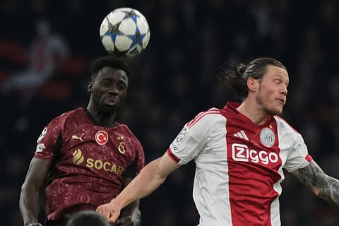 Galatasaray's Davinson Sanchez, left, and Ajax's Wout Weghorst jump fpr the ball during the Champions League between Ajax and Galatasaray in Amsterdam, Netherlands.