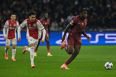 Ajax's Rayane Bounida runs after Galatasaray's goalkeeper Gunay Guvenc during the Champions League between Ajax and Galatasaray in Amsterdam, Netherlands.