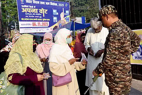 People arrive to cast votes at a polling station during the first phase of Bihar Assembly elections, in Patna.