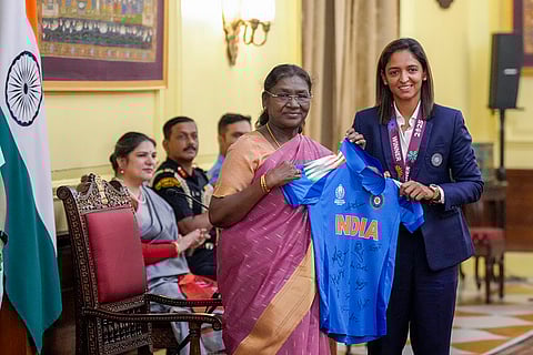 President Droupadi Murmu being presented the team's jersey by women's cricket team captain Harmanpreet Kaur during a meeting following the team's victory in the ODI World Cup, at Rashtrapati Bhavan, in New Delhi.