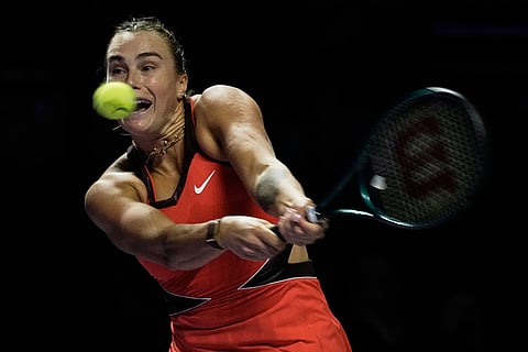Aryna Sabalenka of Belarus plays a backhand return to Coco Gauff of the United States during their women's singles match at the WTA tennis finals in Riyadh, Saudi Arabia.
