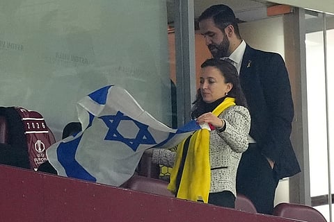 Daniela Grudsky Ekstein the charge d'affaires at the Israeli Embassy to the UK, holds an Israeli flag following the Europa League soccer match between Aston Villa and Maccabi Tel Aviv in Birmingham, England.