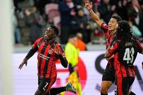 Midtjylland's Franculino Dju, left, celebrates scoring their sides third goal of the game during the Europa League soccer match between FC Midtjylland and Celtic FC in Herning, Denmark.