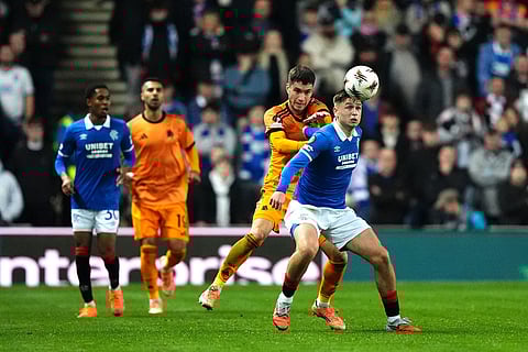 Roma's Matias Soule and Rangers' Mikey Moore, right, in action during the Europa League soccer match between Rangers and Roma in Glasgow, Scotland.