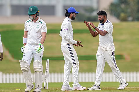India A's Mohammed Siraj celebrates with teammate KL Rahul after taking the wicket of South Africa A's Kyle Simmonds during the second day of the second unofficial Test cricket match between India A and South Africa A, at BCCI Centre of Excellence Ground, in Bengaluru.