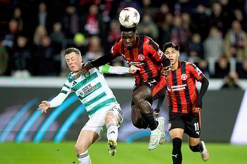 Midtjylland's Franculino Dju, center, and Celtic's Callum McGregor fight for the ball during the Europa League soccer match between FC Midtjylland and Celtic FC in Herning, Denmark.