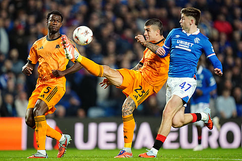 Roma's Evan Ndicka, left, and Gianluca Mancini challenge Rangers' Mikey Moore during the Europa League soccer match between Rangers and Roma in Glasgow, Scotland.