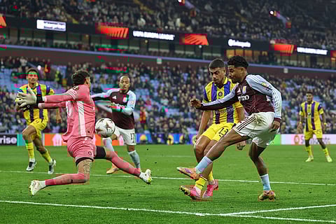 Aston Villa's Ian Maatsen, right, scores his side's opening goal during the Europa League soccer match between Aston Villa and Maccabi Tel Aviv in Birmingham, England.