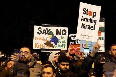 Pro-Palestinian protesters hold up banners outside Villa Park ahead of the Europa League soccer match between Aston Villa and Maccabi Tel Aviv in Birmingham, England.